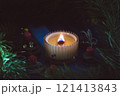 a beautiful scented candle in a transparent holder burns on a dark background. High quality photo 121413843