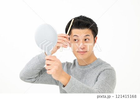 鏡を見て髪を気にする男性 121415168