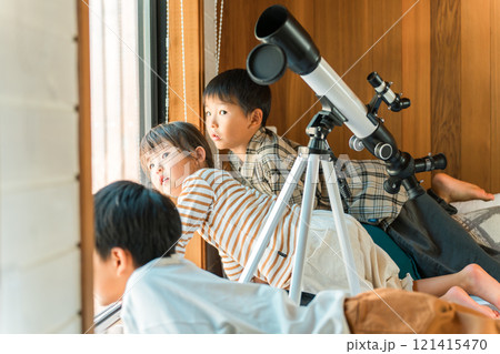 望遠鏡で遊ぶ夏休みの子供達・兄弟・兄妹(コテージ・別荘・山小屋・キャンプ・グランピング) 121415470
