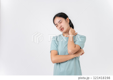 An uncomfortable young Asian woman touching her neck, suffering from neck pain or office syndrome. An uncomfortable young Asian woman touching her neck, suffering from neck pain or office syndrome. 121418198
