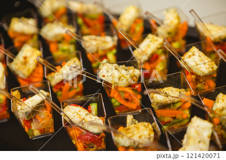 A contemporary hotel dining area featuring a sleek buffet setup. A contemporary hotel dining area featuring a sleek buffet setup. 121420071