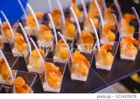 A contemporary hotel dining area featuring a sleek buffet setup. 121420078