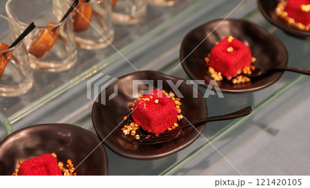 Delicious mini red velvet cakes with cream cheese frosting and grated cheese 121420105