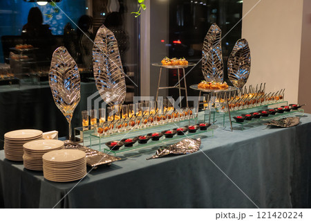 A contemporary hotel dining area featuring a sleek buffet setup and stylish seating arrangement 121420224