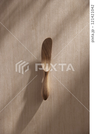 Various tableware on a soft wood-toned table background with sunlight shining through. Various tableware on a soft wood-toned table background with sunlight shining through. 121421042