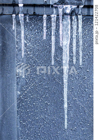 Icicles against a gray wall Icicles against a gray wall 121422708