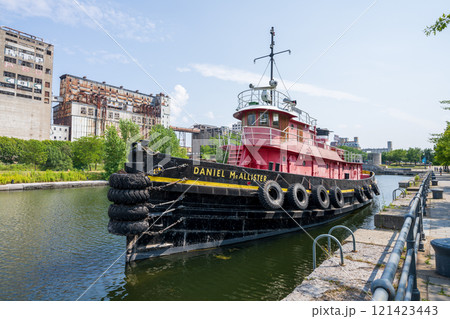 Montreal, Quebec, Canada - August 5 2021 : The tugboat Daniel McAllister, permanently moored in the Lachine Canal National Historic Site in Old Port of Montreal. Montreal, Quebec, Canada - August 5 2021 : The tugboat Daniel McAllister, permanently moored in the Lachine Canal National Historic Site in Old Port of Montreal. 121423443
