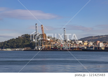 Cruise ship. Boat. Vacation and travel concept with a generic cruise ship sailing on the calm ocean. Luxury cruise liner. Cargo sea port and container terminal. Large cranes on a commercial dock. Cruise ship. Boat. Vacation and travel concept with a generic cruise ship sailing on the calm ocean. Luxury cruise liner. Cargo sea port and container terminal. Large cranes on a commercial dock. 121425483