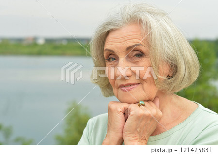 Portrait of a beautiful elderly woman in the park Portrait of a beautiful elderly woman in the park 121425831