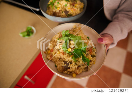 Delicious Bowl of Vegetable Paella Garnished With Fresh Parsley Ready to Enjoy Delicious Bowl of Vegetable Paella Garnished With Fresh Parsley Ready to Enjoy 121429274