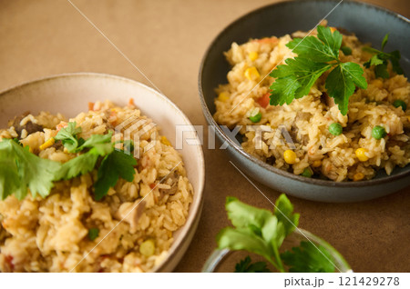 Delicious homemade vegetable rice dish with herbs served in ceramic bowls Delicious homemade vegetable rice dish with herbs served in ceramic bowls 121429278