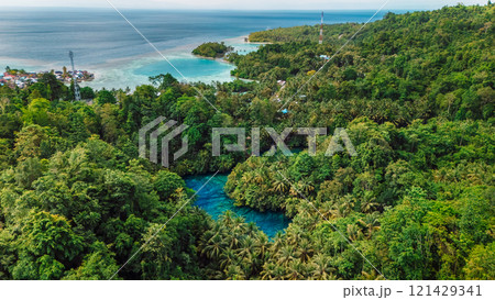 Transparent lake with crystal blue water and ocean coastline in Sulawesi, Indonesia. Drone view Transparent lake with crystal blue water and ocean coastline in Sulawesi, Indonesia. Drone view 121429341