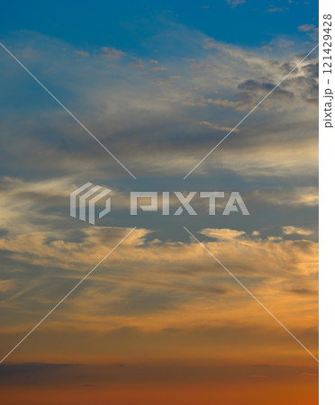 Real majestic sunrise sundown sky background with gentle colorful clouds without birds. 121429428