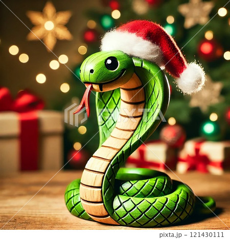 Green snake, symbol of the New Year 2025. Cute snake in a red Santa Claus hat near the Christmas tree. 121430111