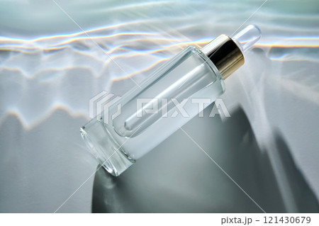 Bottle of face serum with a pipette with a beautiful highlight. 121430679