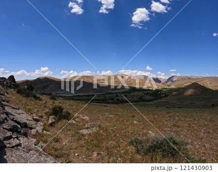 Endless steppe against the backdrop of a blue sky 121430903