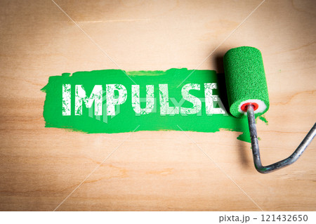 Impulse. Text and green paint and paint roller on wooden background 121432650