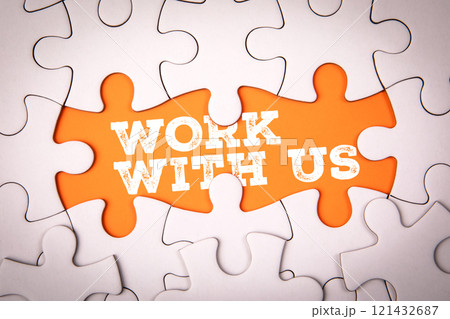 WORK WITH US. White puzzle pieces and text on an orange background WORK WITH US. White puzzle pieces and text on an orange background 121432687