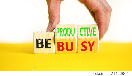 Be productive not busy symbol. Concept words Be productive Be busy on wooden block. Beautiful yellow table white background. Businessman hand. Business be productive not busy concept. Copy space. 121433004