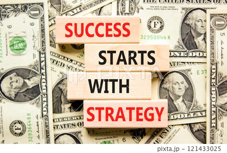 Success starts with strategy symbol. Concept words Success starts with strategy on beautiful wooden blocks. Beautiful dollar background. Business and success starts with strategy concept. Copy space. 121433025
