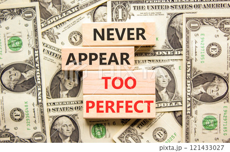 Never appear too perfect symbol. Concept words Never appear too perfect on beautiful wooden blocks. Beautiful background from dollar bills. Business and never appear too perfect concept. Copy space. 121433027