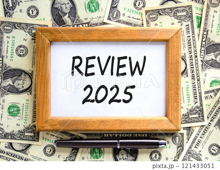Planning review 2025 new year symbol. Concept words Review 2025 on beautiful wooden picture frame. Beautiful background from dollar bills. Black pen. Business review 2025 new year concept. Copy space. 121433051