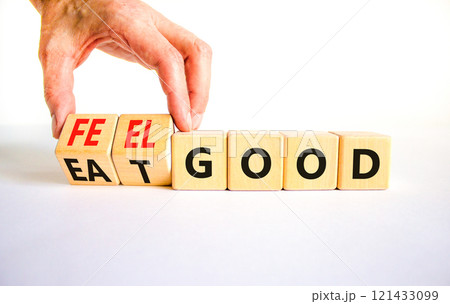 Eat and feel good symbol. Concept words Eat good Feel good on wooden cubes. Beautiful white table white background. Doctor hand. Healthy lifestyle eat and feel good concept. Copy space. Eat and feel good symbol. Concept words Eat good Feel good on wooden cubes. Beautiful white table white background. Doctor hand. Healthy lifestyle eat and feel good concept. Copy space. 121433099