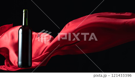 Bottle of red wine and flutters of red cloth. Bottle of red wine and flutters of red cloth. 121433396