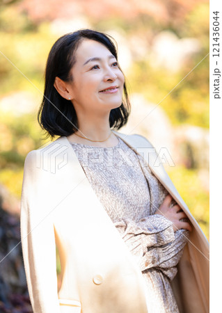 自然豊かな公園を散策する笑顔のミドル女性 自然豊かな公園を散策する笑顔のミドル女性 121436044