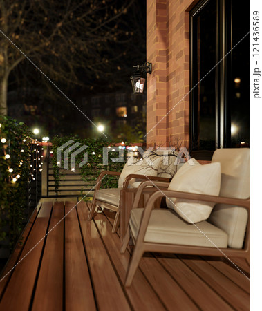 The exterior of a rustic brick outdoor balcony at night designed for relaxation, featuring armchairs 121436589