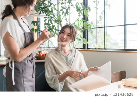 カフェでメニュー表を見ながら注文・オーダーする若いアジア人女性 カフェでメニュー表を見ながら注文・オーダーする若いアジア人女性 121436629