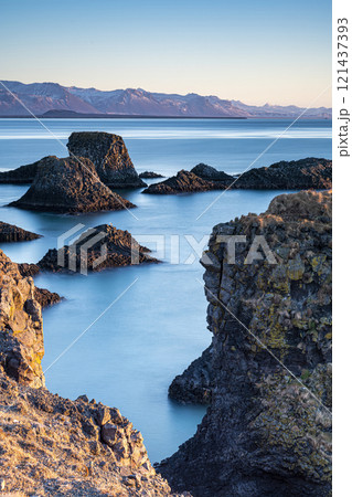 Panoramic view of rock cliffs with sunshine on the coast from Dyrholaey, Iceland Panoramic view of rock cliffs with sunshine on the coast from Dyrholaey, Iceland 121437393