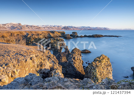 Panoramic view of rock cliffs with sunshine on the coast from Dyrholaey, Iceland 121437394