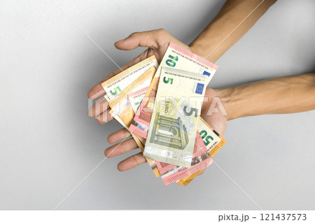 Human hand holding euro banknote cash on white background 121437573