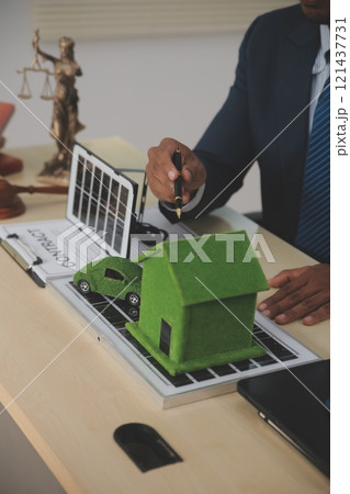 Auctioneer knocks down property sale by sample house and lawyer's gavel, judge mediates in property dispute in court car judge's gavel on wooden background Buying and selling real estate, housing 121437731