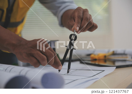 Image of engineer meeting for architectural project. working with partner and engineering tools on workplace vintage tone. Image of engineer meeting for architectural project. working with partner and engineering tools on workplace vintage tone. 121437767