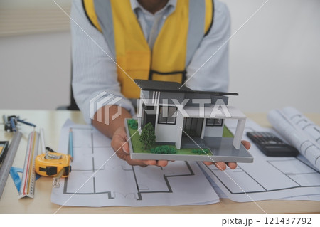 Architects, engineers, contractors working in the office with blueprints, inspection engineers Work analysis for architectural plan, construction project sketch, focus, business construction concept. 121437792