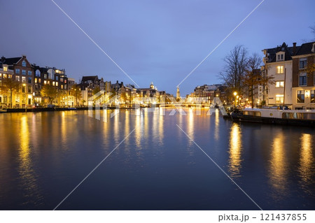 Canal in Amsterdam with illuminated buildings and reflection on the water Canal in Amsterdam with illuminated buildings and reflection on the water 121437855