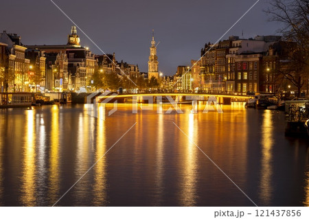 Canal in Amsterdam with illuminated buildings and reflection on the water Canal in Amsterdam with illuminated buildings and reflection on the water 121437856