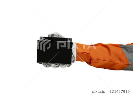 Mechanic hand in glove holding black motorcycle battery isolated over white background Mechanic hand in glove holding black motorcycle battery isolated over white background 121437919