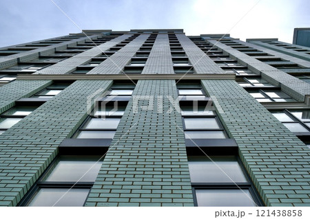 Modern residential building facade viewed from below. Modern residential building facade viewed from below. 121438858