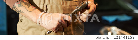 Mechanic Repairing Car With Wrench 121441158