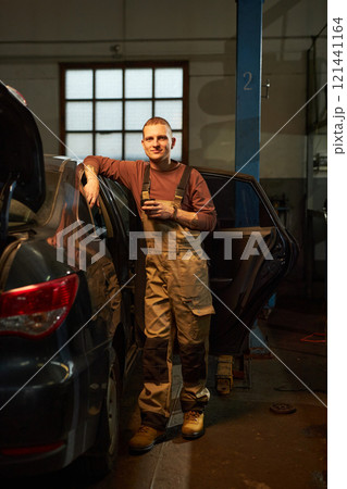Mechanic Drinking Coffee In Service 121441164