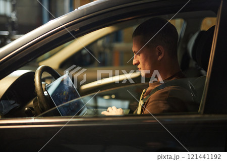 Mechanic Doing Car Diagnostics With Laptop 121441192
