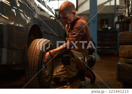 Mechanic Working In Tire Service Mechanic Working In Tire Service 121441213
