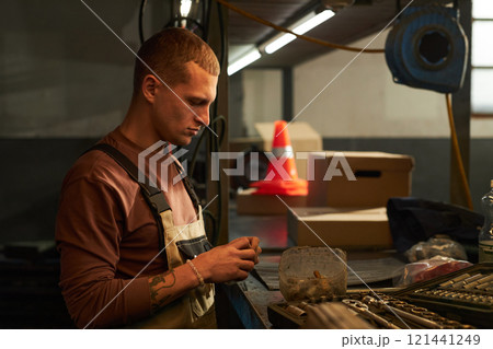 Mechanic Using Tools At His Work Mechanic Using Tools At His Work 121441249