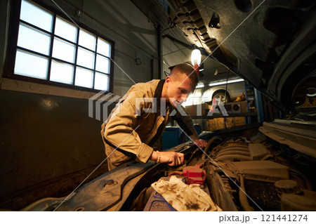 Mechanic Working With Broken Car Mechanic Working With Broken Car 121441274