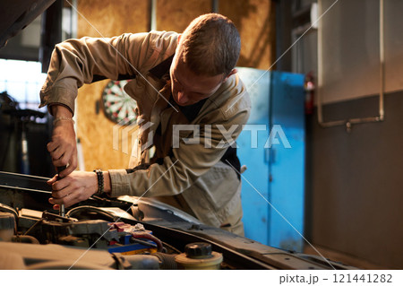Mechanic Using Tools To Repair Engine Mechanic Using Tools To Repair Engine 121441282