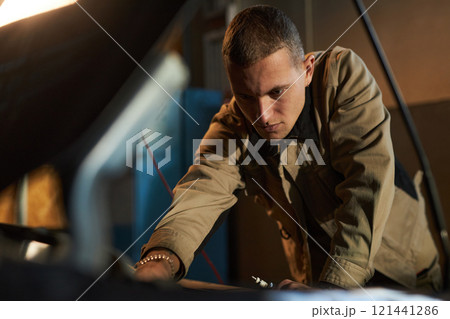 Mechanic Performing Diagnostics In Car Service 121441286