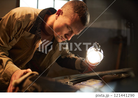 Mechanic Performing Engine Diagnostics Of Automobile Mechanic Performing Engine Diagnostics Of Automobile 121441290